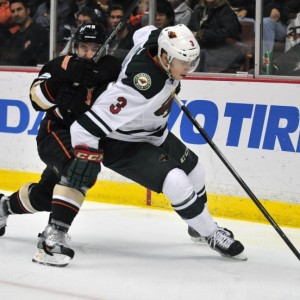 Charlie Coyle powers his way around an Anaheim defender.