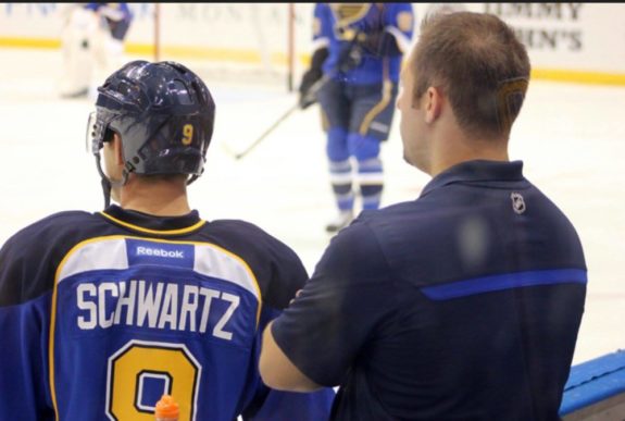 Blues Assistant Equipment Manager Chad O'Neil analyzes a Blues' warm up last season.