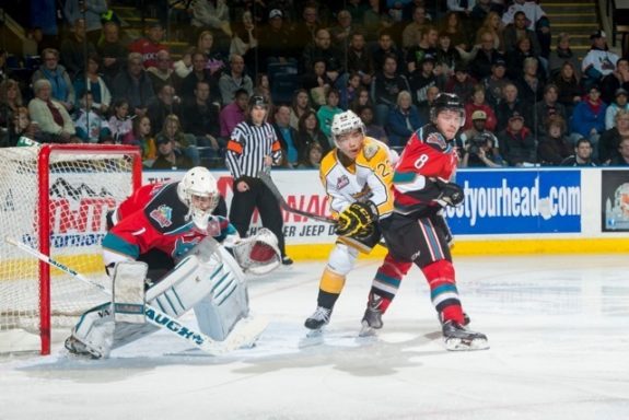 (Marissa Baecker/www.shootthebreeze.ca) Brandon Wheat Kings leading scorer Tim McGauley provides a net-front presence against the Kelowna Rockets as Cole Martin defends and goaltender Jackson Whistle watches for an incoming shot during WHL regular-season action on Oct. 25.