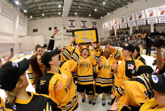 Alyssa Gagliardi holds up Denna Laing's no. 24 as the Boston Pride celebrate their Isobel Cup win. (Photo Credit: Troy Parla)