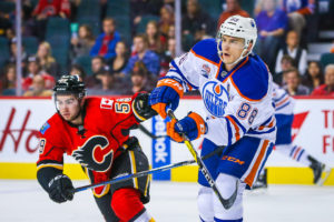 Edmonton Oilers defenseman Brandon Davidson and Calgary Flames left wing Dillon Dube (Sergei Belski-USA TODAY Sports)