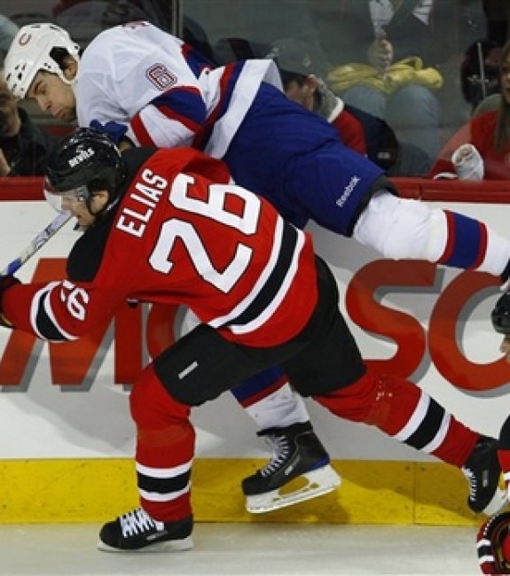 Patrik Elias throws a hit against a future teammate, Tom Kostopoulos. (AP photo/The Canadian Press,Paul Chiasson)