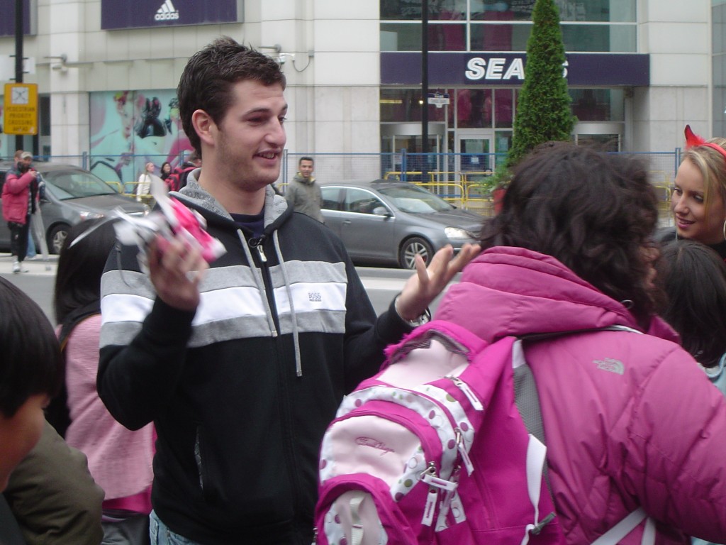Darryl Boyce indicates to a group of sweet-toothed students that he is out of candy at Toronto's Yonge & Dundas Square.