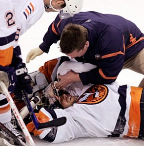 DiPietro in his familiar state of being attended to by the Islanders' training staff