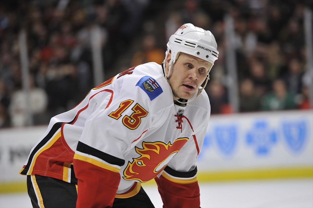 Olli Jokinen of the Calgary Flames moves the puck against Mike News  Photo - Getty Images