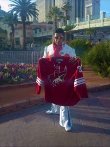 Elvis poses with Coyotes sweater across the street from Bellagio