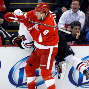 Justin Abdelkader checks Chicago Blackhawks defenseman Michal Rozsival