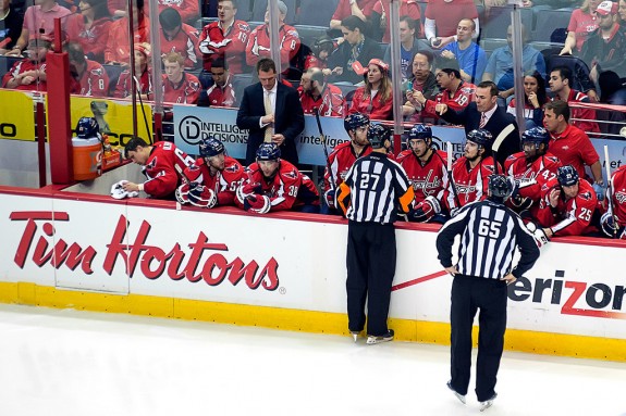 Referee Eric Furlatt addresses the Capitals' bench (Flickr/Clydeorama)