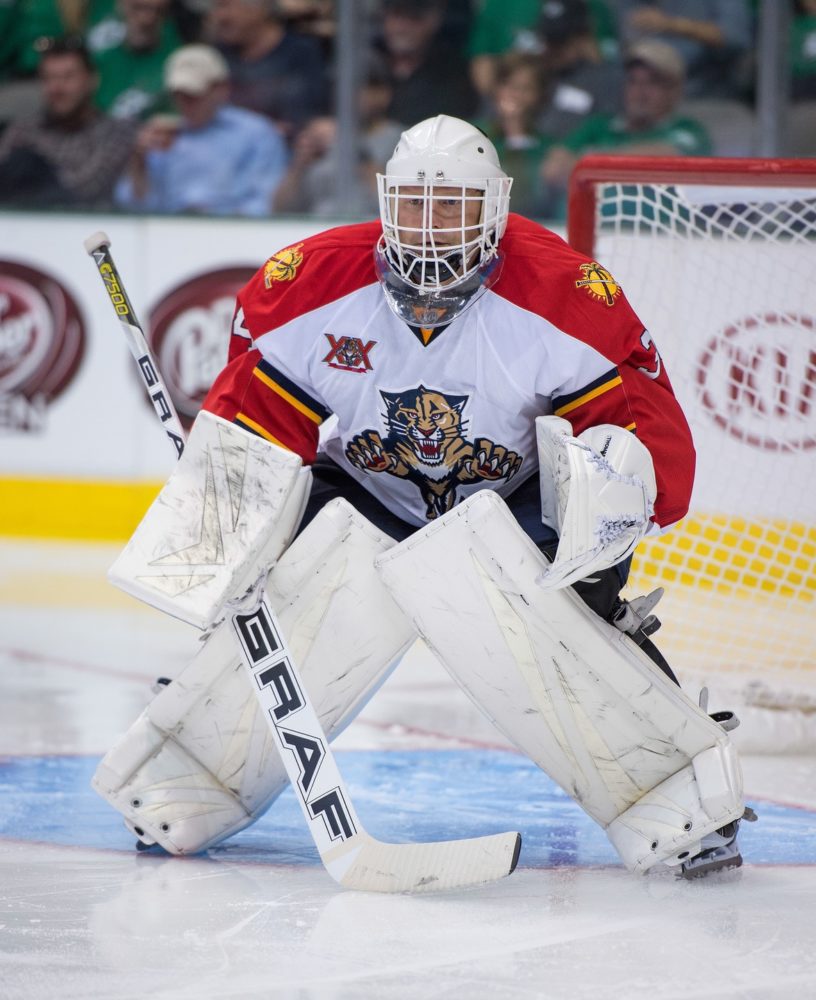 Boston Bruin goaltender Tim Thomas ducks as the puck comes off the