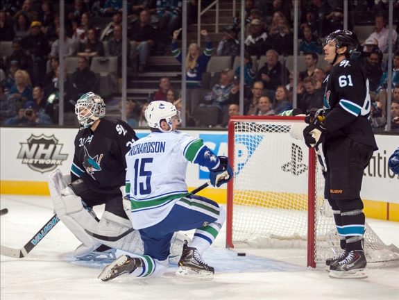 Nov 7, 2013; San Jose, CA, USA; Vancouver Canucks center Brad Richardson (15) scores against San Jose Sharks goalie Antti Niemi (31) during the first period at SAP Center at San Jose. Mandatory Credit: Ed Szczepanski-USA TODAY Sports