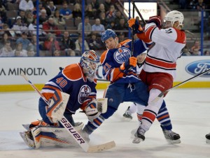 Staal spars with Andrew Ference in a net-mouth battle against the Edmonton Oilers. (Chris Austin-USA TODAY Sports)