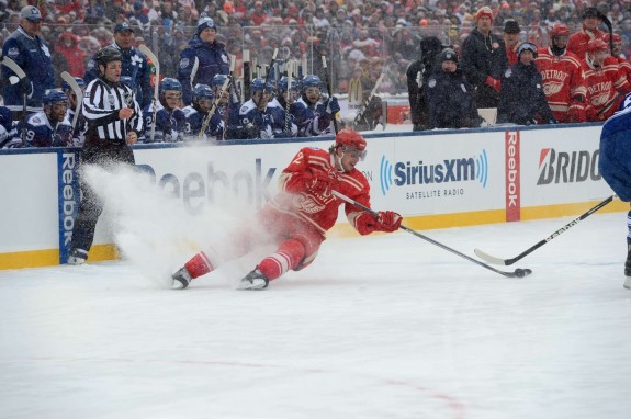 A Red Wing stops hard on his skates creating a snow flurry (Tom Turk/The Hockey Writers)