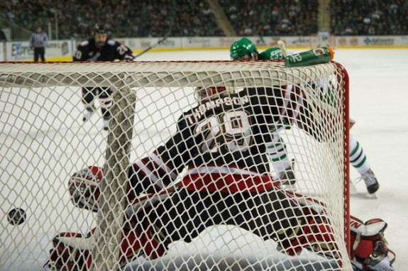 UND's Derek Rodwell scores on UNO goalie Kirk Thompson (Eric Classen/UND Athletics)