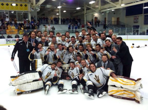 Players from the Arizona State University hockey team (Tempe,Arizona) pose with the National Championship Trophy