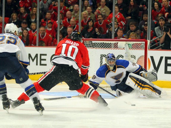 Blackhawks left wing Patrick Sharp  scores past St. Louis Blues goalie Ryan Miller with defenseman Kevin Shattenkirk pursuing during the third period in Game 6 of the first round of the 2014 Stanley Cup Playoffs. (Dennis Wierzbicki-USA TODAY Sports)
