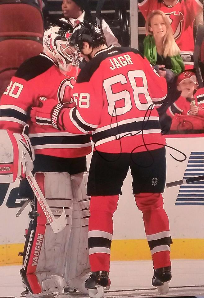 Photo signed by Jaromir Jagr with Alison Kavchok (green scarf) and her son Mat in the background. 