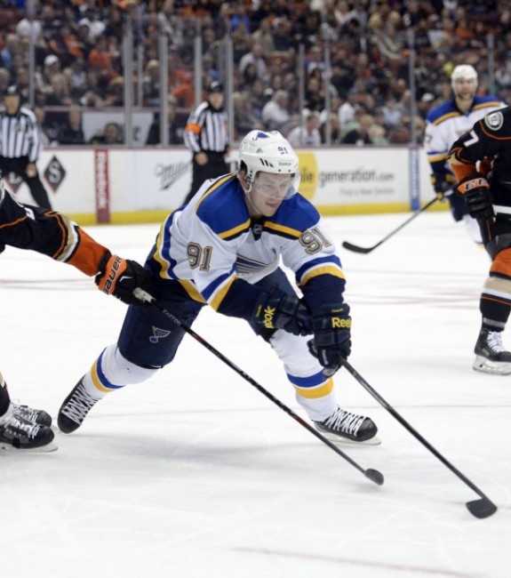 Oct 19, 2014; Anaheim, CA, USA; St. Louis Blues right wing Vladimir Tarasenko (91) reaches for the puck against Anaheim Ducks defenseman Ben Lovejoy (6) during the second period at Honda Center. (Richard Mackson-USA TODAY Sports)