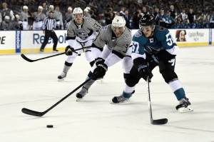 Brayden McNabb and Tommy Wingels skate for the puck in the Stadium Series (Kyle Terada-USA TODAY Sports)