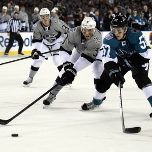 Brayden McNabb and Tommy Wingels skate for the puck in the Stadium Series (Kyle Terada-USA TODAY Sports)