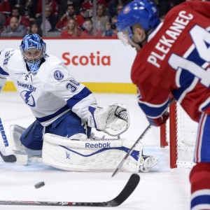 Montreal Canadiens forward Tomas Plekanec and Tampa Bay Lightning goalie Ben Bishop