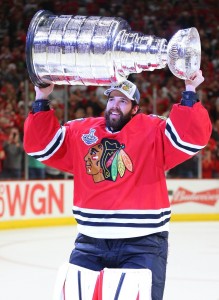 Corey Crawford hoists the Cup with the winning playoff beard intact (Dennis Wierzbicki-USA TODAY Sports)