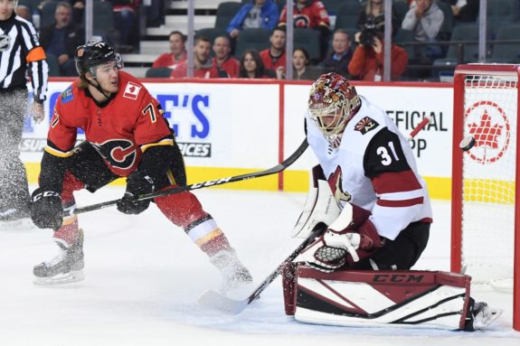 Calgary Flames Mark Jankowski and Arizona Coyotes goalie Adin Hill