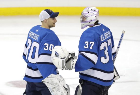 Winnipeg Jets goaltender Laurent Brossoit and Connor Hellebuyck