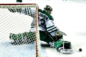 UND goalie Cam Johnson makes a save. (Photo Credit: Russell Hons UNDSports.com)