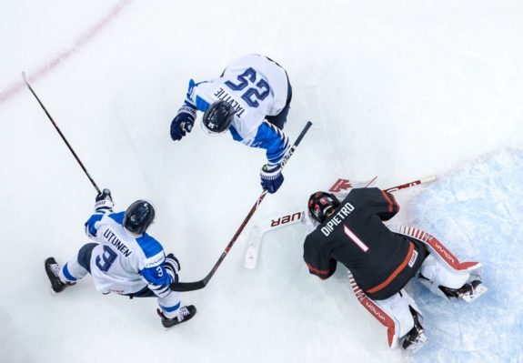 Team Canada Michael DiPietro Team Finland's Toni Utunen and Aarne Talvitie