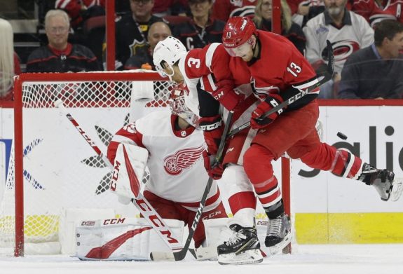 Detroit Red Wings' Nick Jensen and Jonathan Bernier and Carolina Hurricanes' Warren Foegele