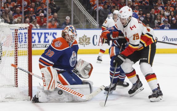 Matthew Tkachuk battles in front of Mikko Koskinen in a Battle of Alberta in Edmonton