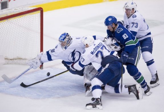 Tampa Bay Lightning Andrei Vasilevskiy tries to stop Vancouver Canucks Christopher Tanev