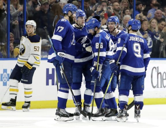 Tampa Bay Lightning right wing Nikita Kucherov (86) celebrates with teammates, including defenseman Victor Hedman (77) and center Tyler Johnson (9) 