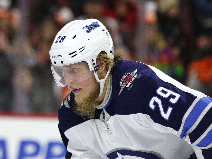 Winnipeg Jets' Patrik Laine (29), of Finland, and Bryan Little (18)  celebrate Little's goal against the Vancouver Canucks during the first  period of an NHL hockey game in Vancouver, on Monday November