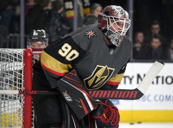 Detroit Red Wings' Luke Glendening, right, watches his shot slip through  the pads of Calgary Flames goalie Mike Smith during second period NHL  hockey action in Calgary, Friday, Jan. 18, 2019.THE CANADIAN