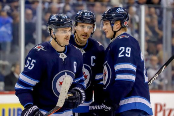 Mark Scheifele #55, Blake Wheeler #26 and Patrik Laine #29 of the Winnipeg Jets