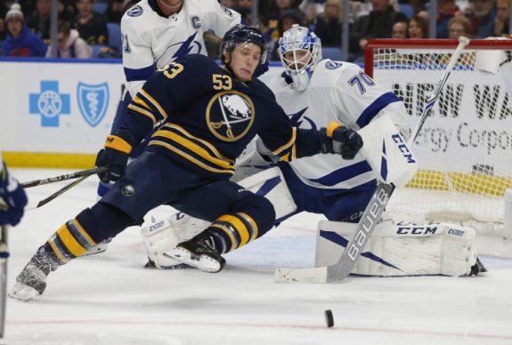 Jeff Skinner falls to the ice as Lightning goalie Louis Domingue watches on. 