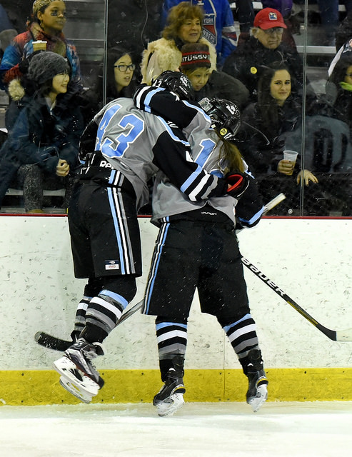 Tatiana Rafter (left) celebrates with Hannah McGowan following her first NWHL goal. (Photo credit: Troy Parla)