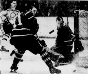 Johnny Bower eyes the puck he just deflected after a shot by Bruins Don Awrey.