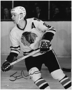 Stan Mikita, sported a helmet for last night's game with Toronto.