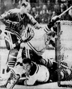 Ed Johnston stops Hawks' Doug Mohns while Forbes Kennedy lends a hand.