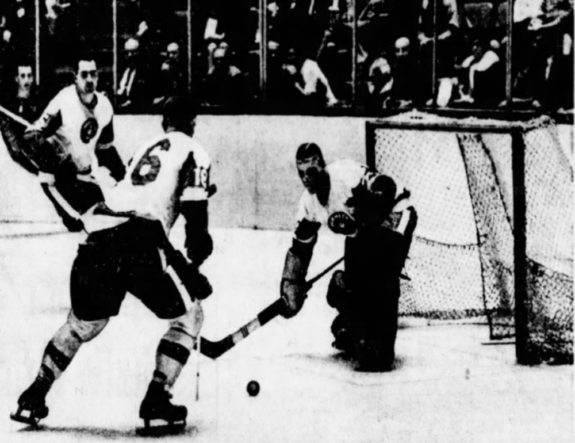 Pittsburgh goalie Don Caley prepares to clear a Springfield shot with the help of team mate Ted Taylor (16)