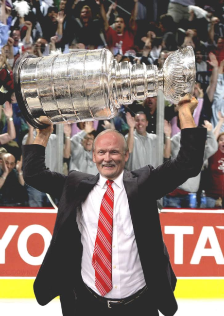 Lindy Ruff hoists the Stanley Cup