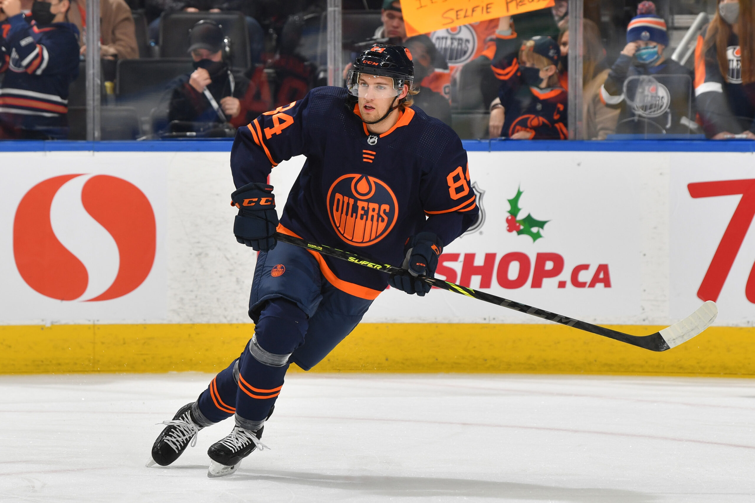 Edmonton Oilers' William Lagesson (84) checks Winnipeg Jets