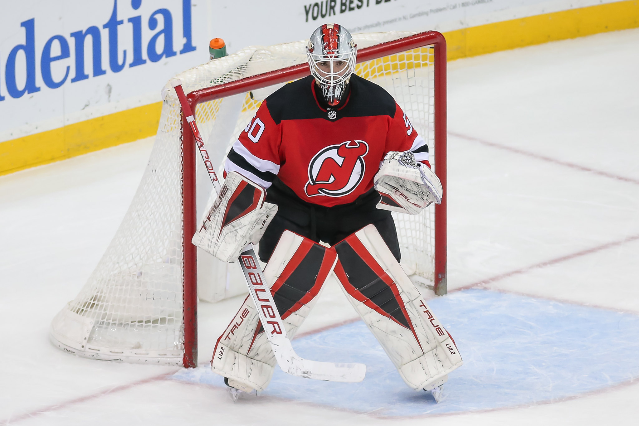 New Jersey Devils goaltender Nico Daws, left, plays briefly with