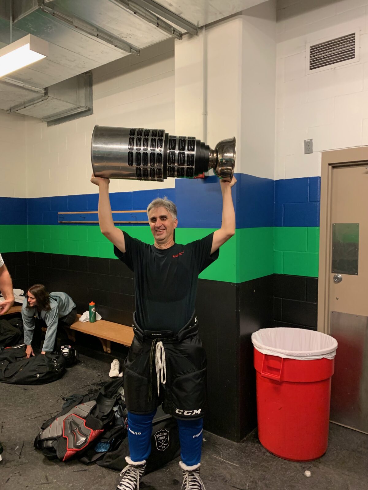 The author hoists the replica Stanley Cup after winning his league championship.